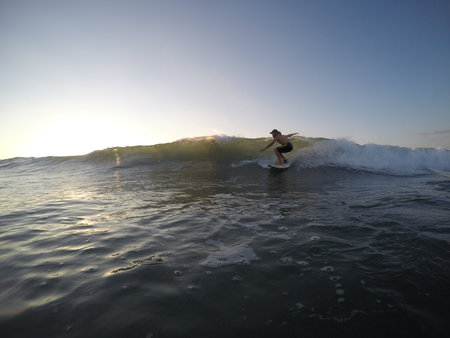 Tamarindo, Costa Rica - People surfing off the beach - travel to central americaの写真素材