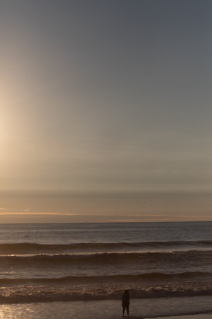 A sunset over a body of water and shadow, Pichilemu, Chile, outdoorの写真素材
