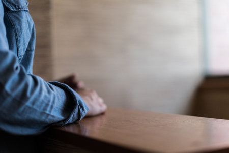 Young person at home office table, waiting in a deskの写真素材