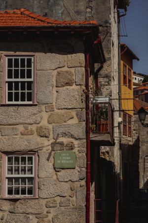 There is a stone building with a sign that says casa on the sideの写真素材