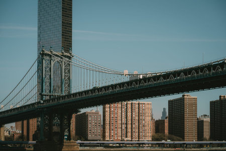 A bridge over serene water with a bustling city in the backgroundの写真素材