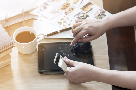 Hand holding card and using tablet for on-line shopping goods and payment service.の写真素材