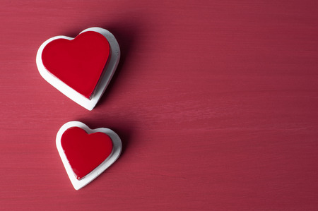 Double red heart on white heart on red grunge background. Valentines concept. Red and white heart with copy space. Love Concept.の写真素材
