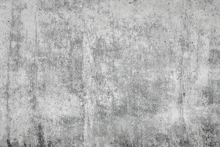 Gray concrete surface with cracks. An image of a cemented surface with a grunge, dirty stain, as an idea for making a background.の写真素材