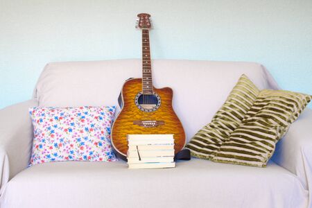 reading an interesting novel in a comfortable chair or learning how to play the guitar are two good options for quarantiningの写真素材
