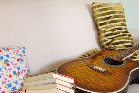 reading an interesting novel in a comfortable chair or learning how to play the guitar are two good options for quarantiningの写真素材
