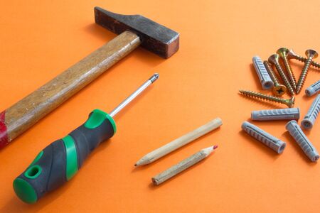 DIY tool set consisting of screws, dowels, screwdriver and hammerの写真素材