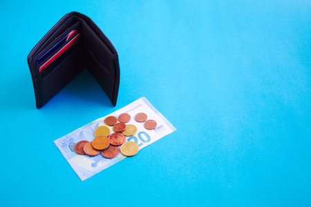 set of banknote, coins and wallet on blue background