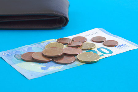 set of banknote, coins and wallet on blue background