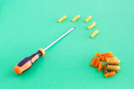 composition of colored spirals and screwdriver on eye-catching backgroundの写真素材