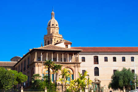 Monumental old building with the tower of the Cathedral of Murcia in the backgroundのeditorial素材