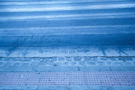 Safety separation signs due to the pandemic on the roadの写真素材