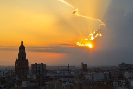Spectacular sunset over the city of Murcia with the cathedral tower in the foregroundの写真素材