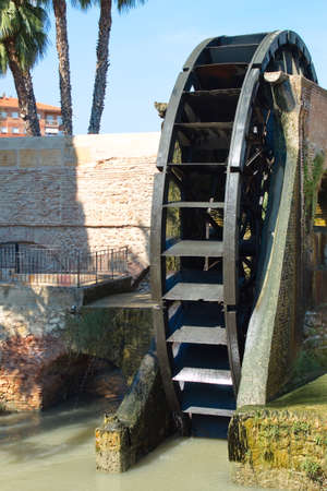 Old water wheel or ferris wheel to irrigate the garden of Murciaの写真素材