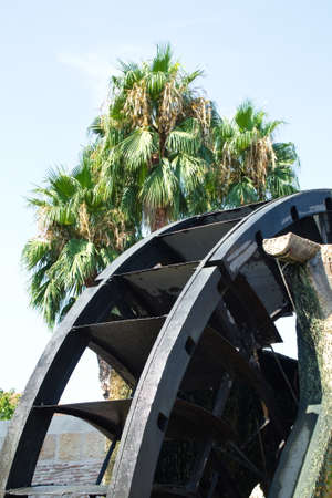 Old water wheel or ferris wheel to irrigate the garden of Murciaの写真素材