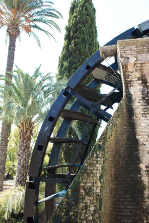 Old water wheel or ferris wheel to irrigate the garden of Murciaの写真素材