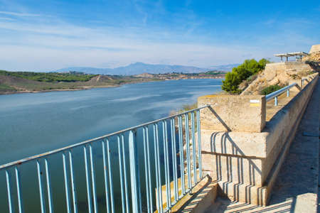 Nice panoramic view of the Santomera reservoir on a sunny dayの写真素材