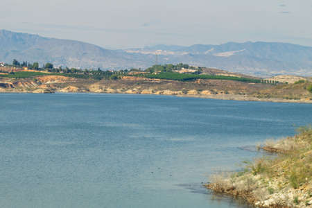Nice panoramic view of the Santomera reservoir on a sunny dayの写真素材