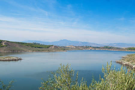 Nice panoramic view of the Santomera reservoir on a sunny dayの写真素材