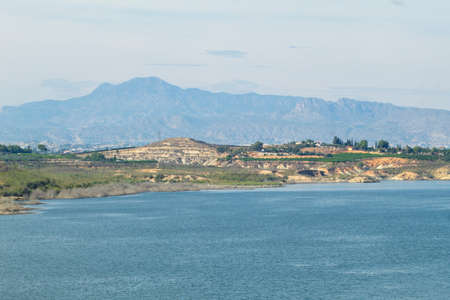 Nice panoramic view of the Santomera reservoir on a sunny dayの写真素材