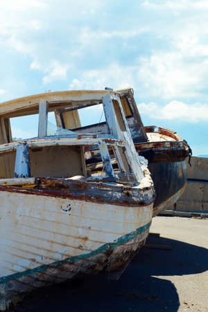 Old abandoned boat on the dock of the fishing portの写真素材