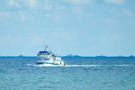 Nice seascape with boats going through the surf in vacation timeの写真素材