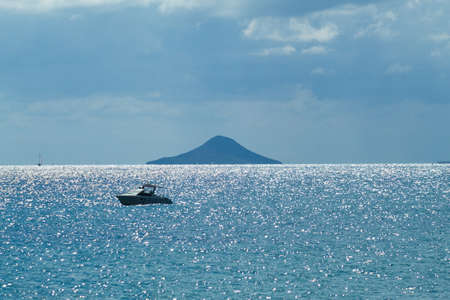 Nice seascape with boats going through the surf in vacation timeの写真素材