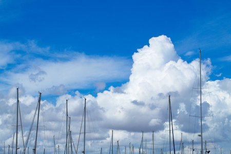 Nice landscape with ship masts on sky background with cloudsの写真素材