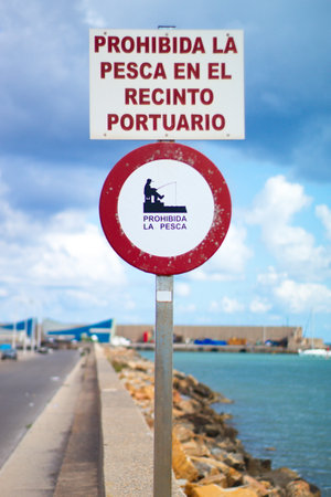 Prohibition sign at the entrance of the port that says: "fishing prohibited in the port area"の写真素材