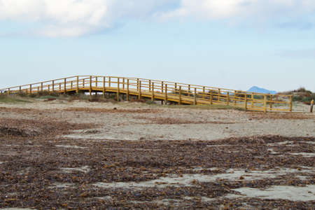 Wooden walkway to access the beach to bathe in blue beachesの写真素材
