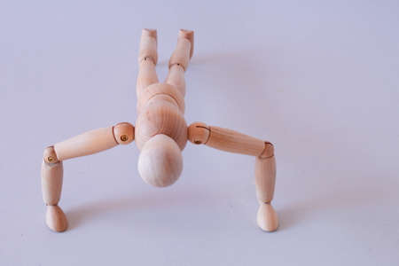 Wooden figure as a model for exercising at homeの写真素材