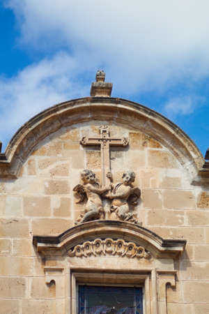 Nice baroque facade with sculpture of the Iglesia de Santa Eulalia in Murcia on a sunny dayの写真素材
