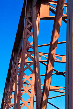 Metal structure of an old bridge with a useful design to support the weight of cars and trucks that cross the riverの写真素材