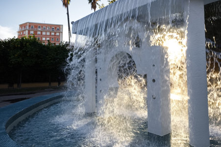 Striking fountain with cascading water in a garden in the city of Murciaの写真素材
