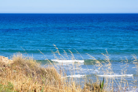 Striking scene of waves breaking on the sand of a Spanish beachの写真素材