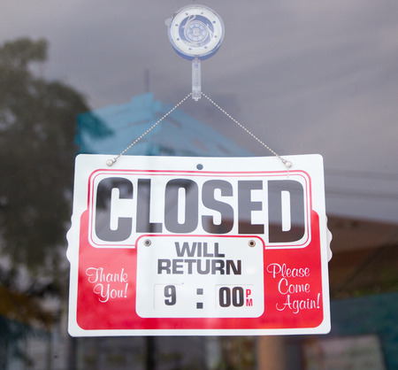 Closed sign in a shop with reflectionsの写真素材