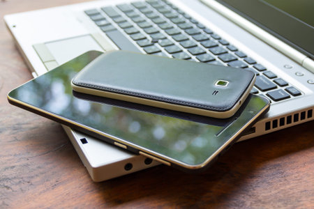 laptop with tablet and smart phone on table