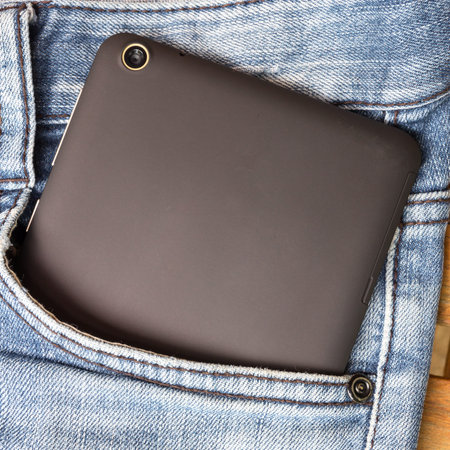 The black tablet in a pocket of a jeansの写真素材