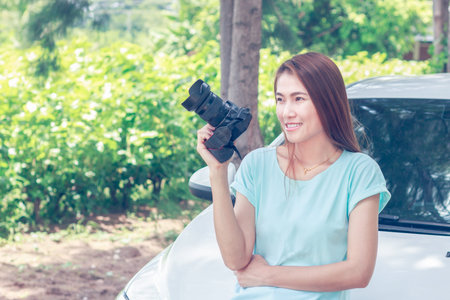 Pretty woman is a photographer with slr camera