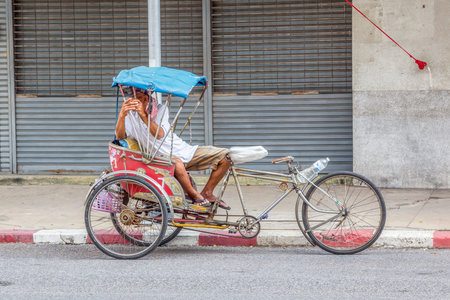Nakhon Ratchasima, THAILAND - Nov 15, 2015 : Tricycle bicycle taxi can not parking at the street for customers on Nov 15, 2015 in Korat,Thailand. Tricycle bicycle taxi is one of the public transport in Thailand.のeditorial素材