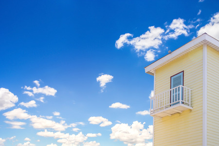 Old wooden country house with a balcony on a sunny dayの写真素材