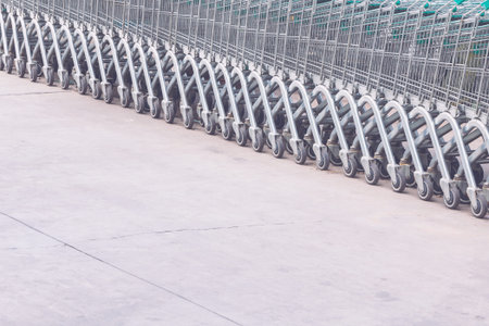 row of empty shopping carts in the supermarket