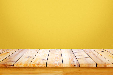 Empty wooden table with yellow gradient wall background. For display or montage your products