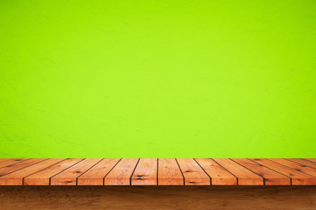 Empty wooden table with green wall background. For display or montage your products.
