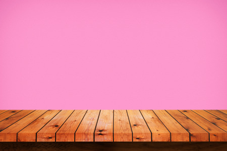 Empty wooden table with pink gradient wall background. For display or montage your productsの写真素材