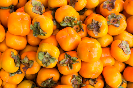 Background of orange persimmons fruit.の写真素材