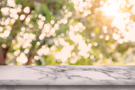 Empty white marble table with bokeh abstract green background. For display or montage your products.
