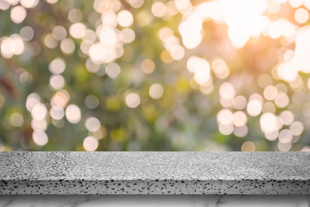 Empty marble table with bokeh abstract green background. For display or montage your products.