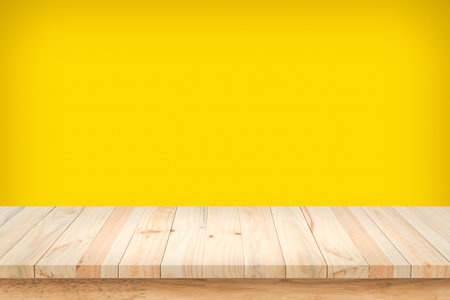 Wood table top on yellow wall background.の写真素材