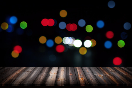 Wooden floor and city light with bokeh night background. For display or montage your products.の写真素材